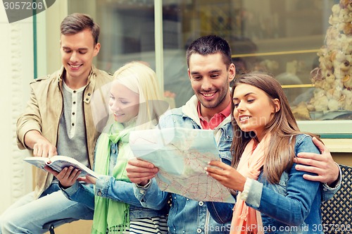 Image of group of friends with guide and map exploring town