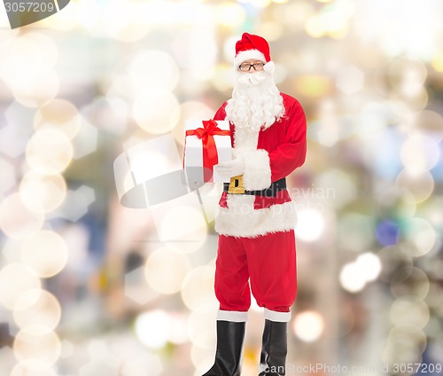 Image of man in costume of santa claus with gift box