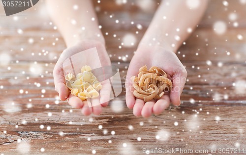 Image of close up of hands with different pasta variations