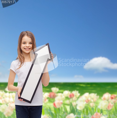 Image of smiling little girl with blank arrow pointing up