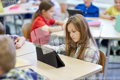 Image of school kids with tablet pc in classroom