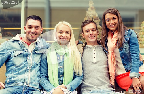 Image of group of smiling friends in city