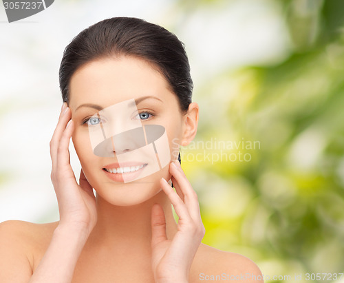 Image of beautiful young woman over green background