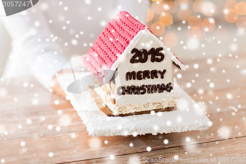 Image of close up of woman showing gingerbread house