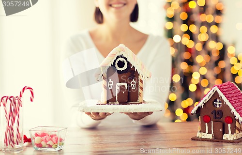 Image of close up of woman showing gingerbread house