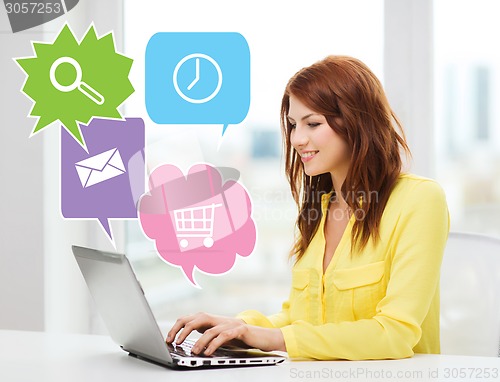 Image of smiling woman with laptop computer at home