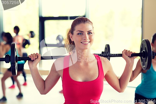 Image of group of women with barbells in gym