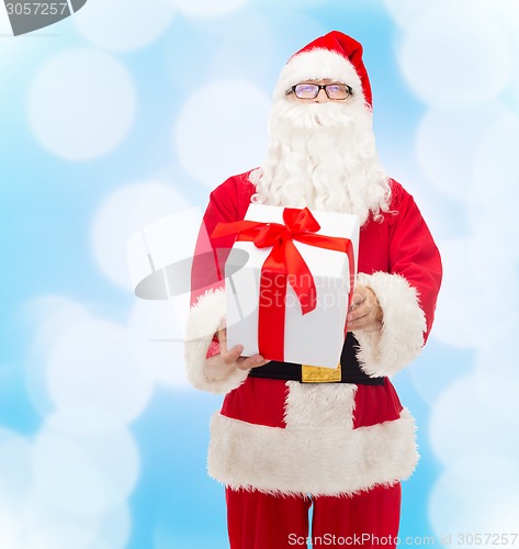 Image of man in costume of santa claus with gift box