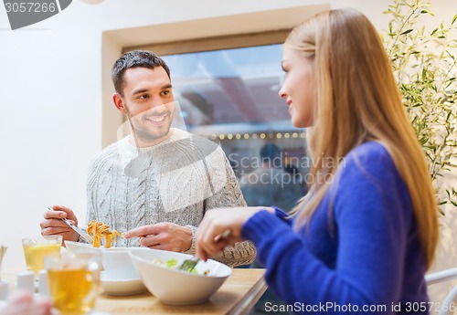 Image of happy couple meeting and having dinner at cafe