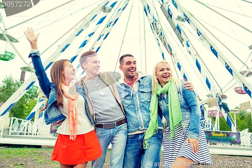 Image of group of smiling friends waving hands