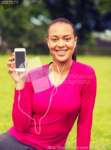 Image of smiling african american woman with smartphone