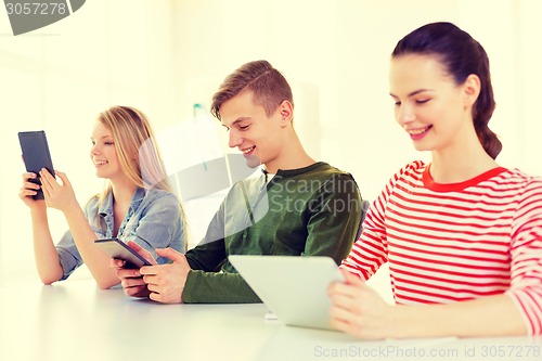 Image of smiling students with tablet pc at school