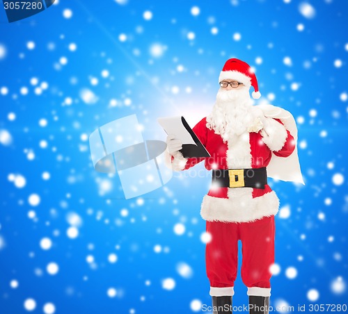 Image of man in costume of santa claus with notepad and bag