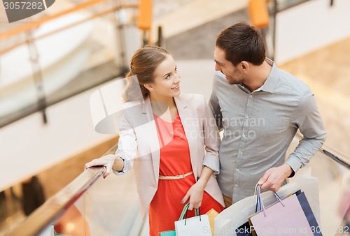 Image of happy young couple with shopping bags in mall