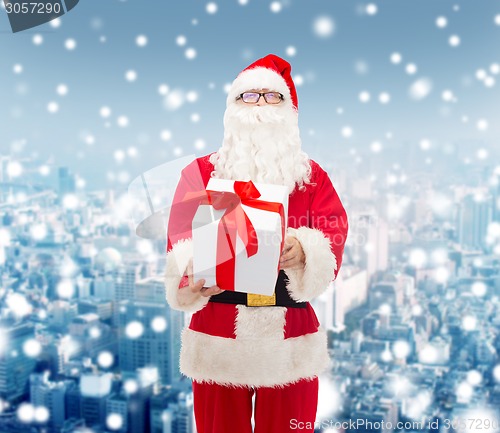 Image of man in costume of santa claus with gift box