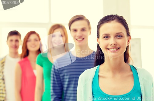 Image of smiling students with teenage girl in front
