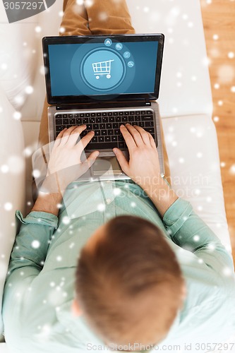 Image of close up of man working with laptop at home