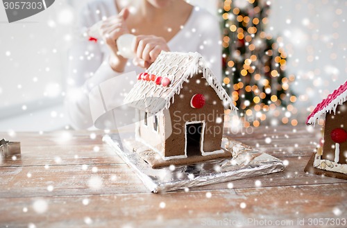 Image of close up of woman making gingerbread houses