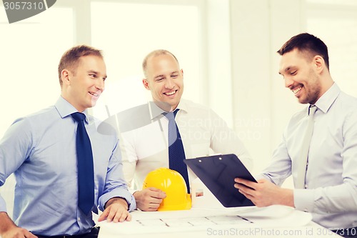 Image of happy team of architects and designers in office