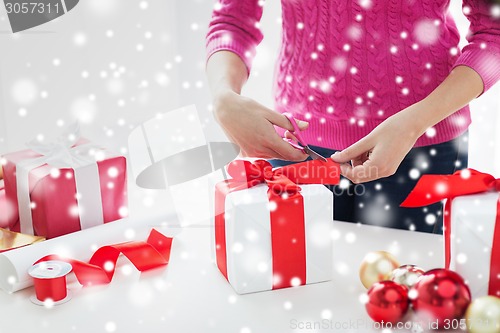 Image of close up of woman decorating christmas presents