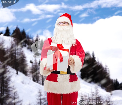 Image of man in costume of santa claus with gift box