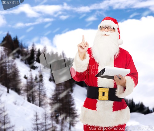Image of man in costume of santa claus with notepad