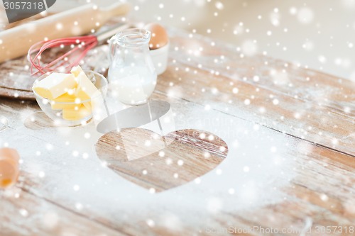 Image of heart of flour on wooden table at home