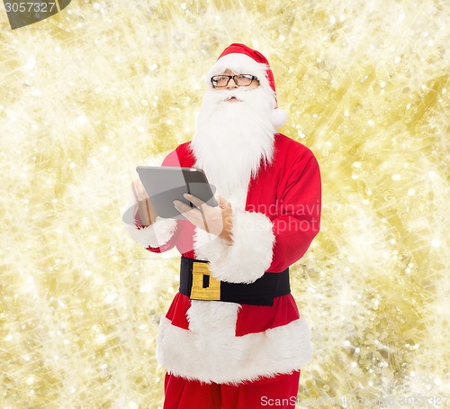 Image of man in costume of santa claus with tablet pc