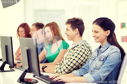 Image of female student with classmates in computer class