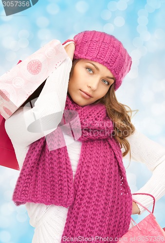 Image of smiling young woman with shopping bags