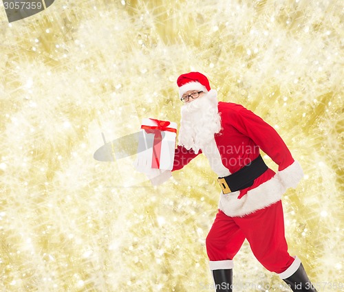 Image of man in costume of santa claus with gift box