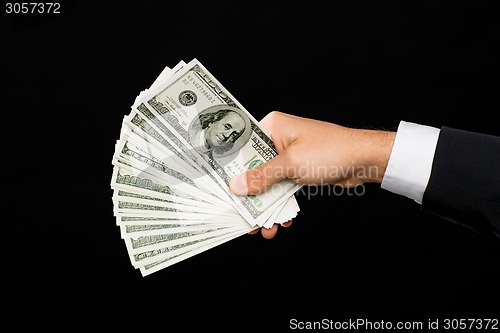 Image of close up of male hands holding dollar cash money