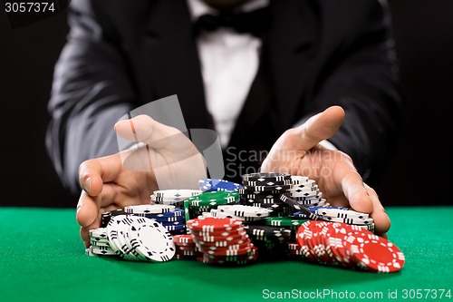 Image of poker player with chips at casino table