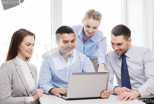 Image of business team working with laptop in office