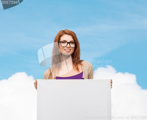 Image of smiling teenage girl in glasses with white board
