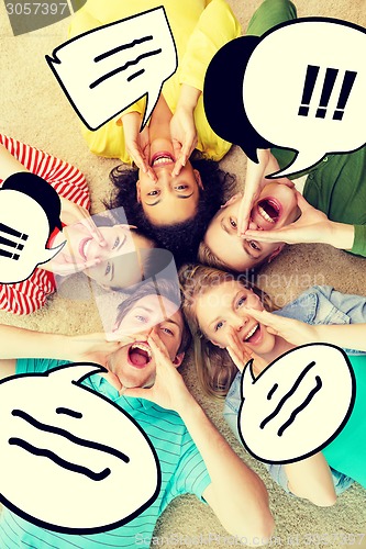 Image of smiling people lying down on floor and screaming