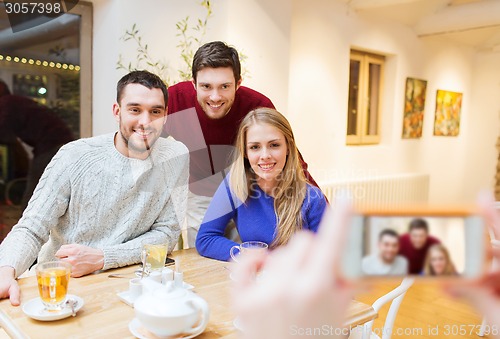Image of group of friends taking picture with smartphone