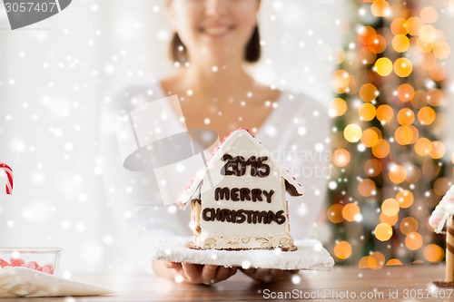 Image of close up of woman showing gingerbread house