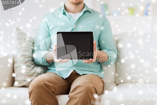 Image of close up of man with tablet pc computer at home