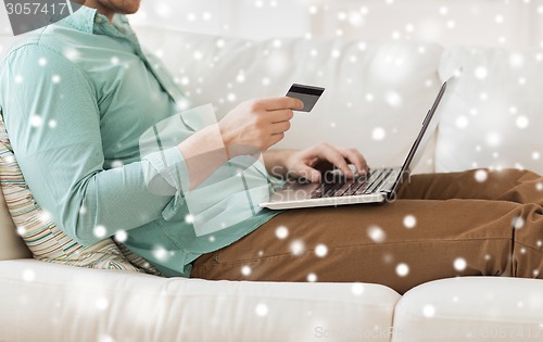 Image of close up of man with laptop and credit card