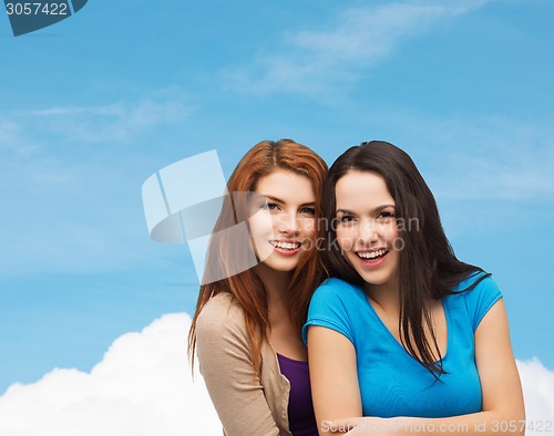 Image of smiling teenage girls hugging