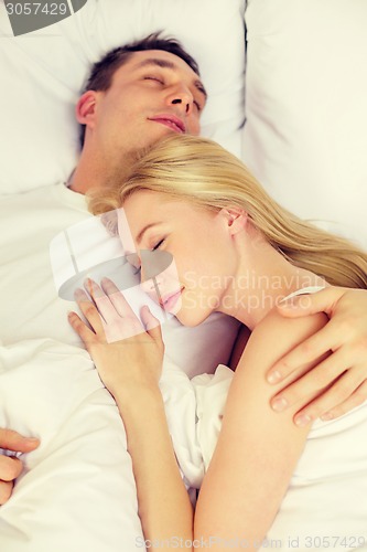 Image of happy couple sleeping in bed