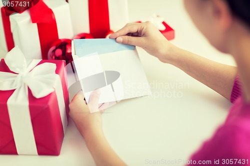 Image of close up of woman with letter and presents