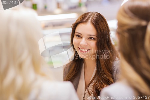 Image of smiling young women meeting and talking