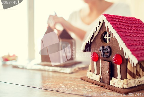 Image of close up of woman making gingerbread houses