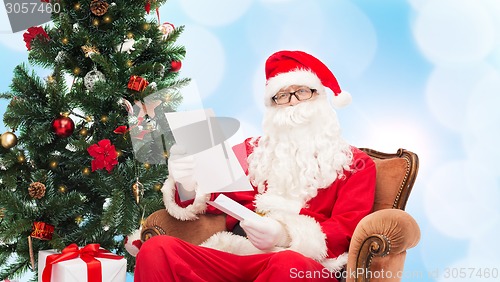 Image of man in costume of santa claus with letter