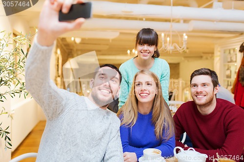 Image of group of friends taking selfie with smartphone