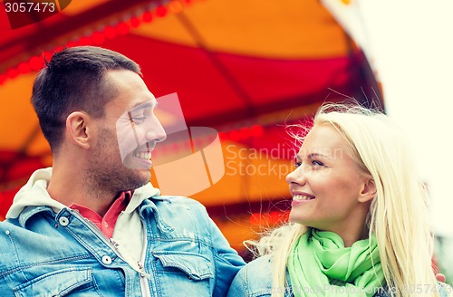 Image of smiling couple in amusement park