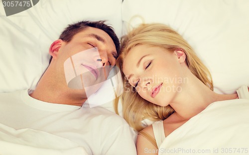 Image of happy couple sleeping in bed