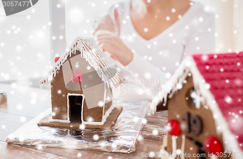 Image of close up of woman making gingerbread houses